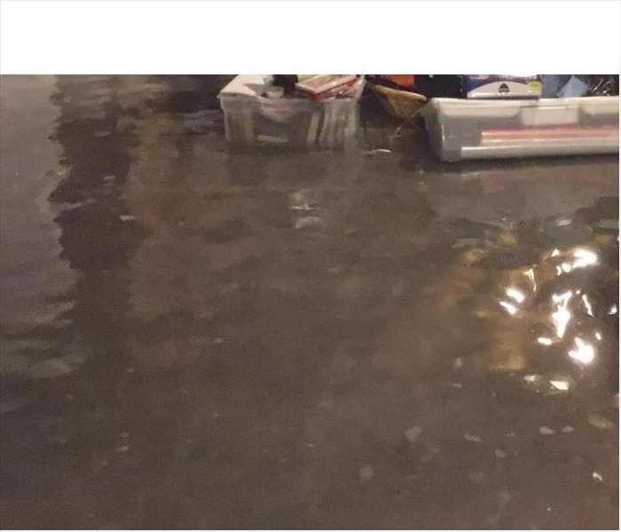 Flooded basement floor with homeowner belongings floating